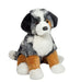 Plush toy dog with black, white, and brown fur on a white background