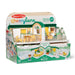 Melissa & Doug Cheerylane house play set in its original retail packaging, featuring a miniature two-story house with green and white checkered details, yellow furniture accents, and small doll figures.