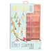 Simply Charming STMT DIY Jewelry kit in its retail packaging, featuring a light blue box with gold lettering and a pink translucent plastic charm tray visible behind it.