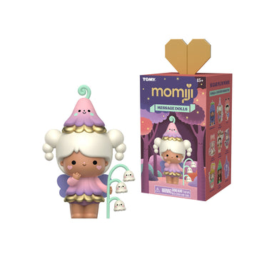 A TOMY Momiji message doll figure with a pink and purple mushroom-shaped hat, white hair, and a small green hanging toy, shown next to its illustrated retail box on a plain white background.