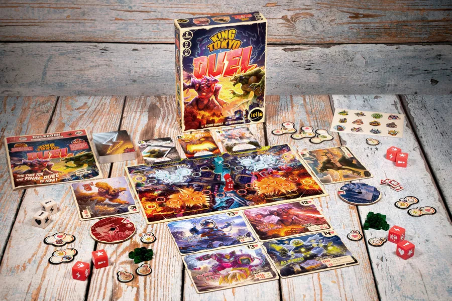 Board game set up on a wooden surface with colorful game pieces and King of Tokyo Duel box.