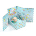Toy figure in a decorative box with bubble-themed design on a white background