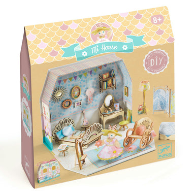 Diy dollhouse kit packaging with illustrations of a dollhouse and furniture on a white background