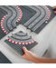 Toy race track set with curved and straight sections on a white surface.