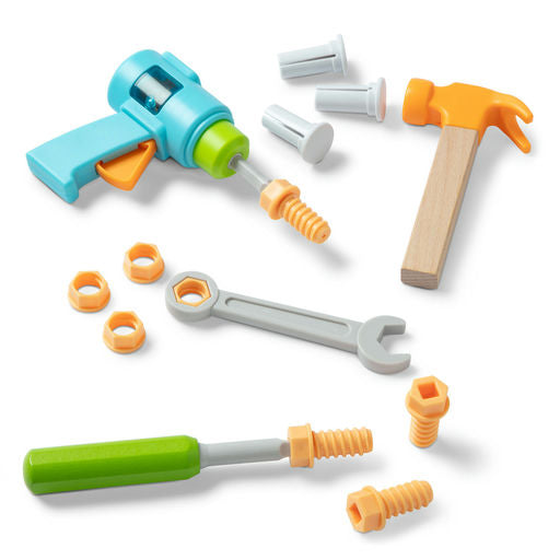 Toy tool set with a drill, hammer, wrench, and various attachments on a white background