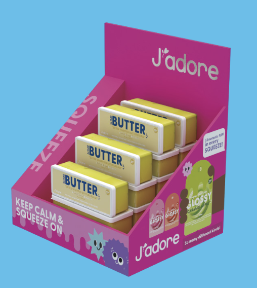 A J'adore squeeze butter display stand filled with yellow and white butter packs, shown on a solid light blue background.