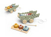 A wooden toy set featuring two crocodile-shaped wagons with colorful xylophones, along with matching wooden blocks and a mallet on a light wood tray, photographed on a clean white background.