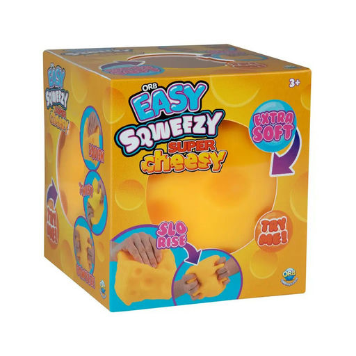 A cube-shaped retail box for 'Ola Easy Squeefzy Super Cheesy' toy, featuring a bright yellow and orange design with illustrations of hands squeezing the toy and text highlighting its soft, extra-soft texture.