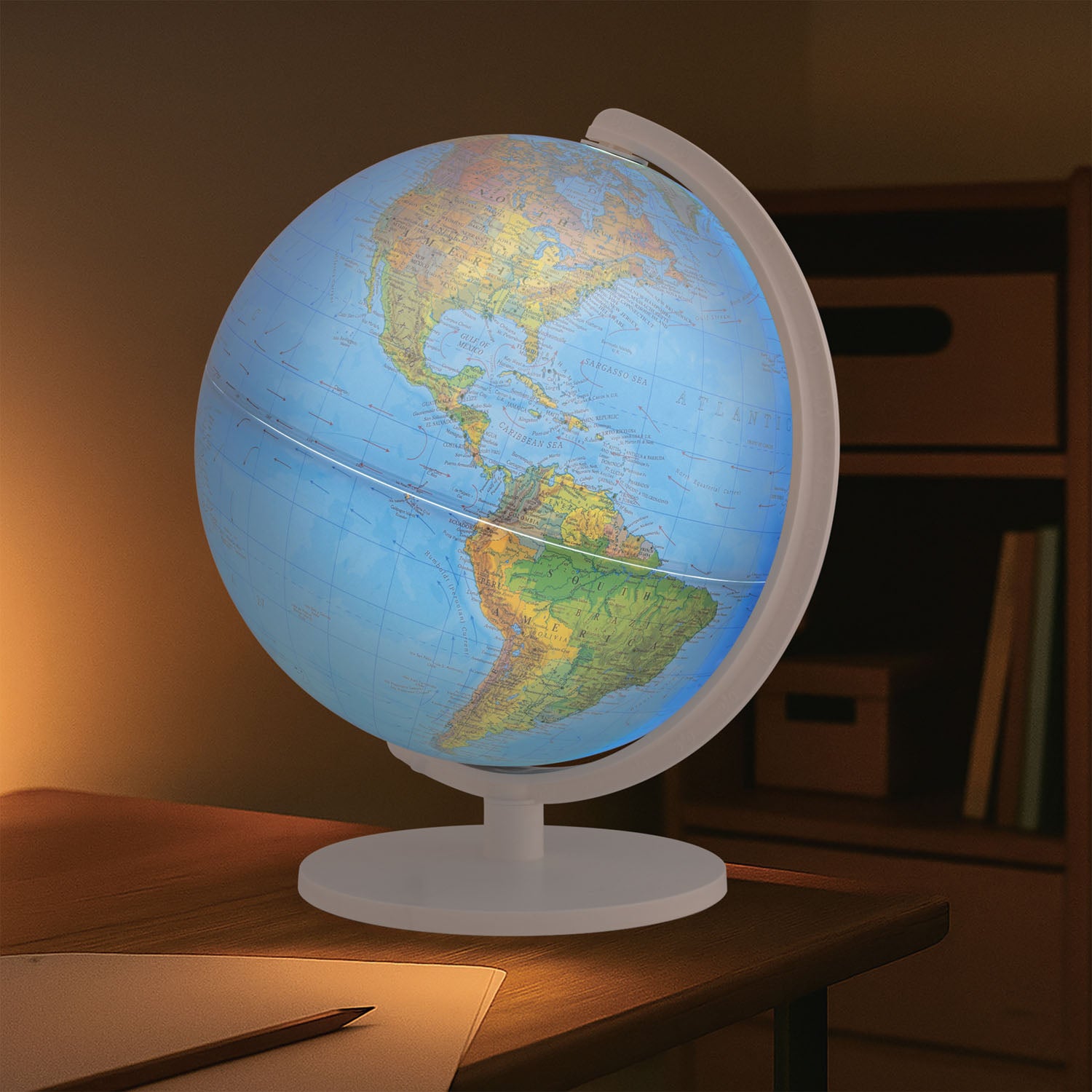 World globe on a wooden table with a warm light in the background
