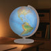 World globe on a wooden table with a warm light in the background