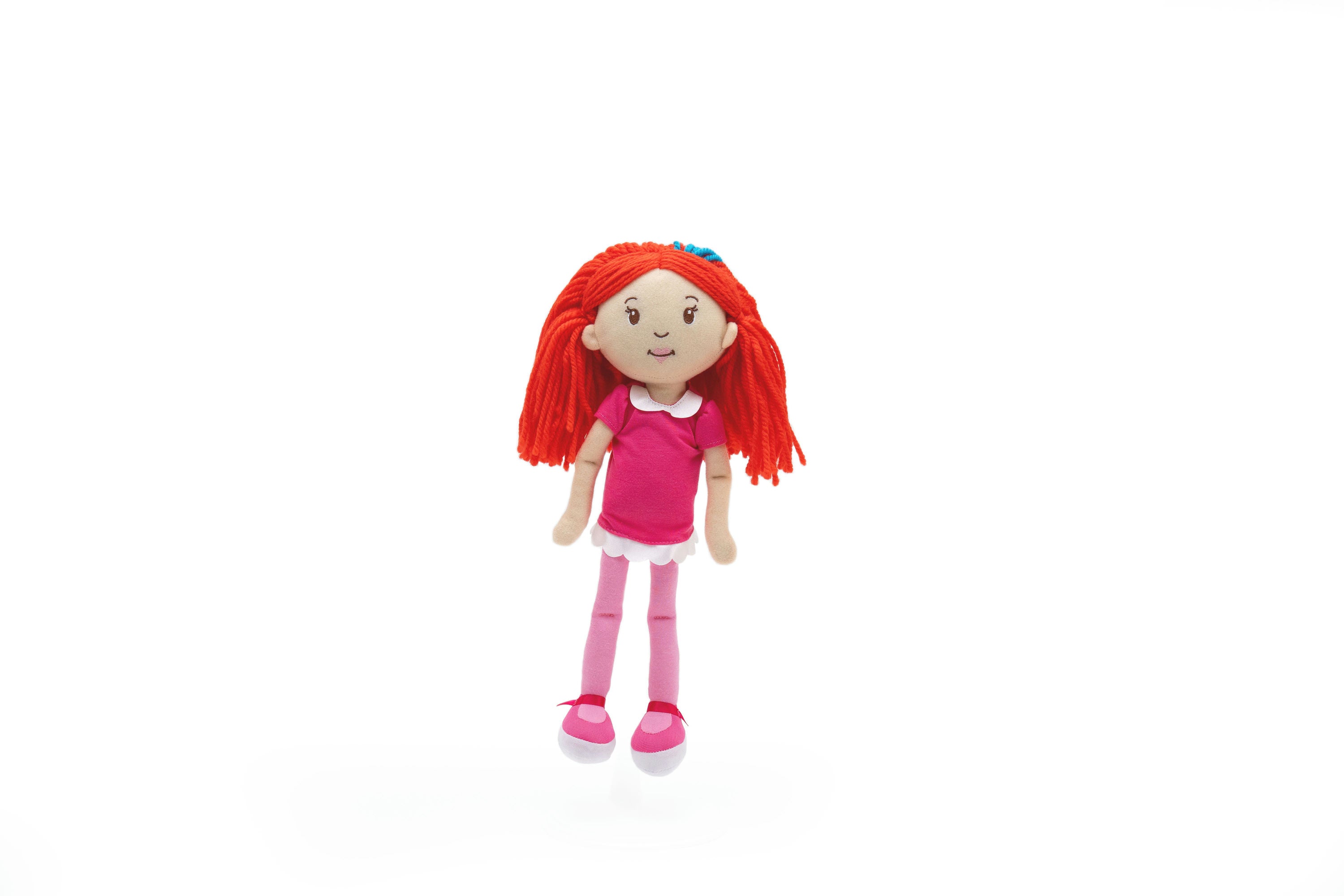 Toy doll with red hair and pink outfit on a white background