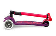 Purple and pink scooter with 'maxi' branding on a white background