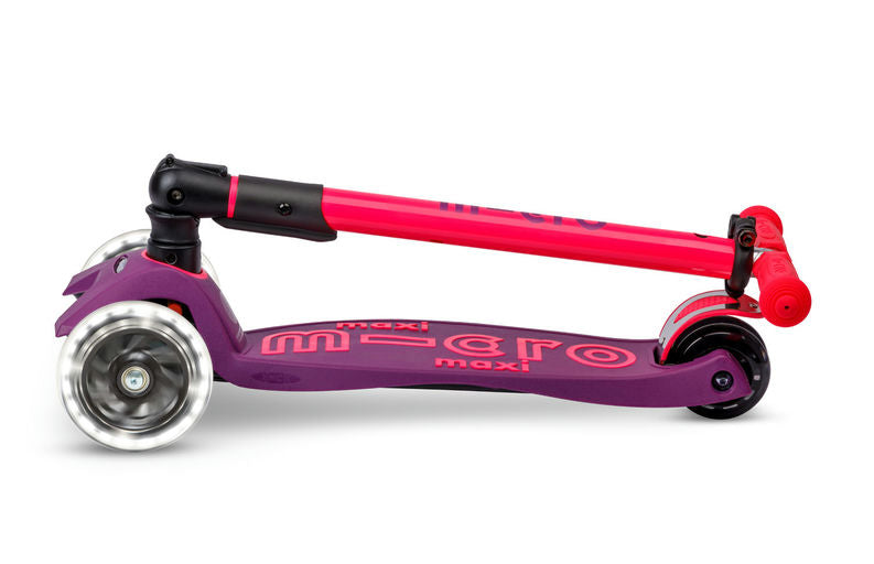 Purple and pink scooter with 'maxi' branding on a white background