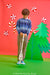 A child stands in a colorful studio setting holding a metal detector. The background is bright red with paper candy canes, peppermint candies, and a green paper Christmas tree.