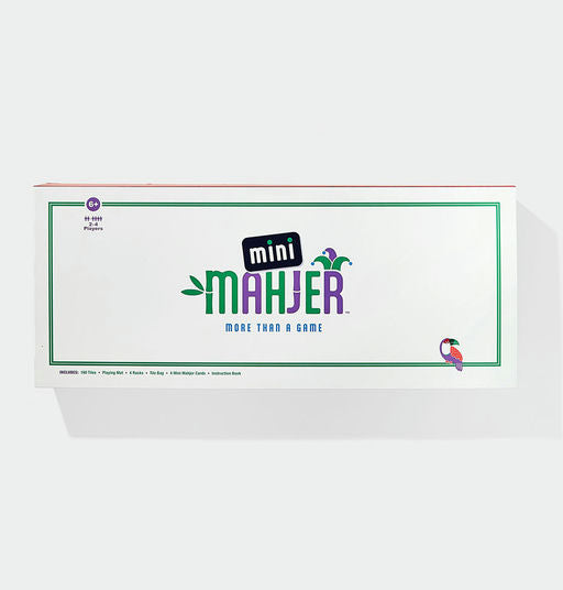 The product packaging for 'mini MAHJER' on a clean white background. The box is white with a green border, featuring the game's title in green and purple lettering, along with a small toucan illustration in the bottom right corner.