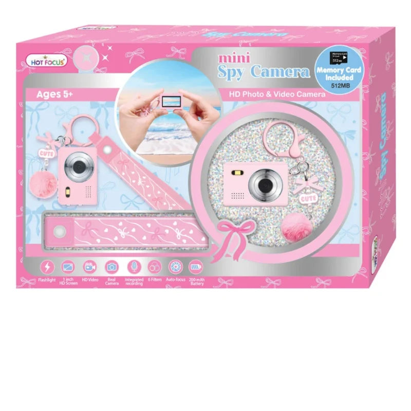 Hot Focus! Mini Spy Camera toy kit in its original pink retail packaging, featuring a pink toy camera, glittery circular accessory, pink ruler, and keychain.