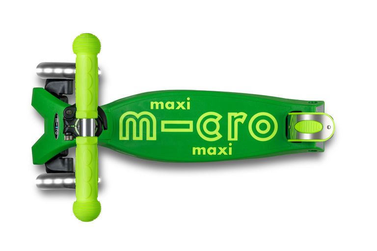 Green scooter with 'maxi micro' branding on a white background