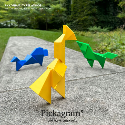 Three colorful origami bird sculptures displayed outdoors on a stone pathway, with green foliage in the background. The birds are in yellow, blue, and green, and the text 'PICKAGRAM - THREE AMIGOS' and 'Pickagram' are visible.