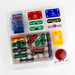 A children's robotics and electronics kit in a clear plastic clamshell package, featuring colorful electronic components such as a blue speaker, red and green buttons, a yellow motor driver, and various connectors on a white background.
