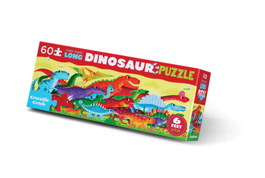 A 6-foot jigsaw puzzle box by Crocodile Creek titled '60-piece Long Dinosaur Puzzle'. The packaging features a colorful illustration of various cartoon dinosaurs on a yellow background with red and blue text accents.