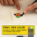 Coloring a small tattoo design on a piece of paper with markers, including text about the product.