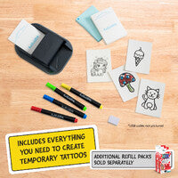 Temporary tattoo kit with tattoo machine, markers, and printed designs on a wooden surface.