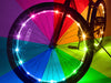 Bicycle wheel with colorful LED lights on a multicolored background