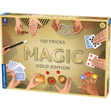 Packaging for 'Magic Gold Edition', a box containing 150 magic tricks with various props like cups, balls, and cards illustrated in the background. The box is designed with a gold color scheme and text indicating the number of tricks and the 'Gold Edition' label.